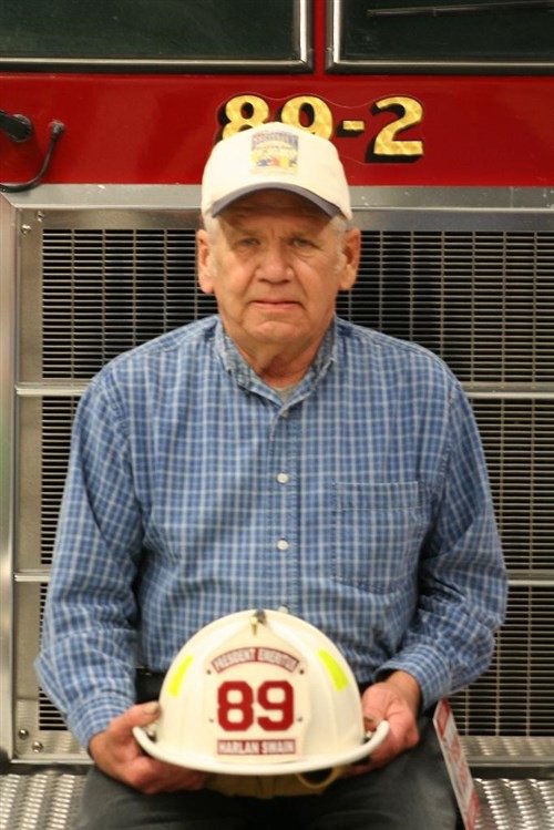 Harlan Swain holding his Station 89 helmet