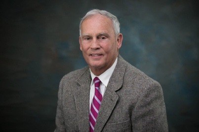Portrait of Dave Kenton in a tweed jacket and striped tie