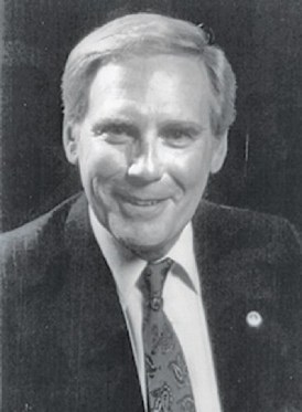 Portrait of Frank Abbott Newton in a dark suit and patterned tie
