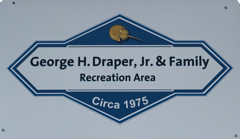 Blue and white sign reading George H. Draper, Jr. and Family Recreation Area, Circa 1975, with a horseshoe crab emblem